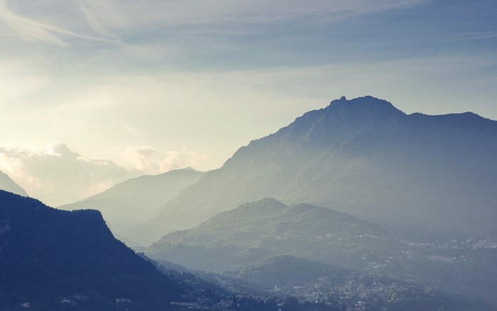 Misty mountain range at sunrise with a valley below