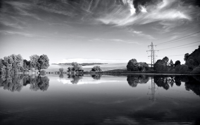 Monochrome landscape with lake and power lines