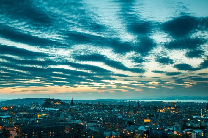 Edinburgh cityscape at dusk with dramatic clouds