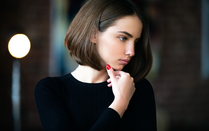 Woman with short brown hair in a black top