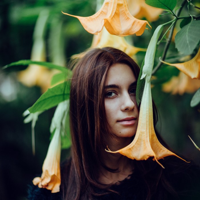 Woman with brown hair among yellow flowers