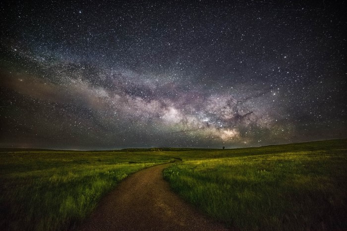 Milky Way over a grassy field with a path