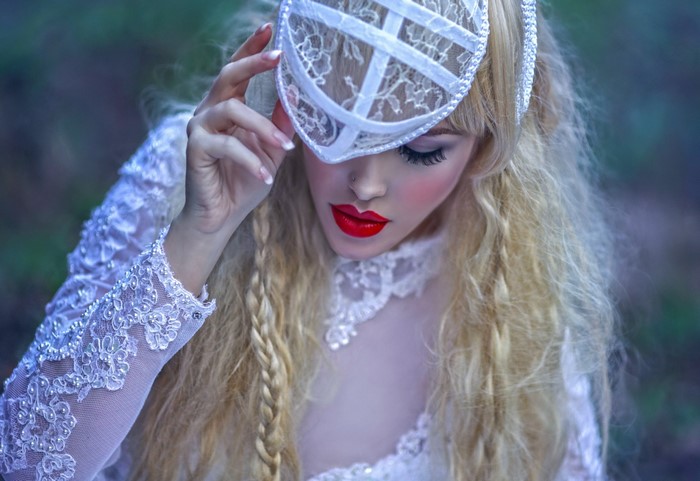 Woman in white lace dress and mask