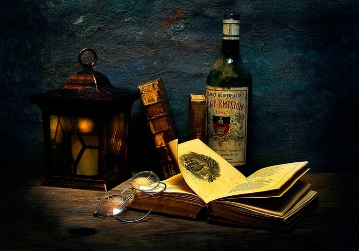 Still life with lantern, books, glasses, and wine bottle
