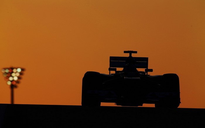 Formula 1 car silhouette at sunset