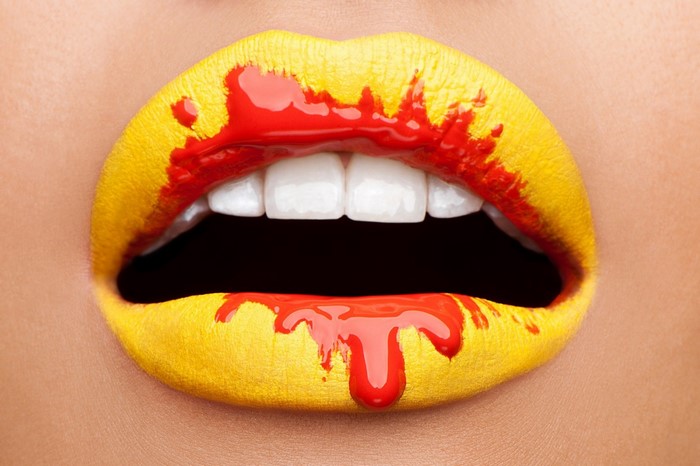 Yellow lips with red paint drips