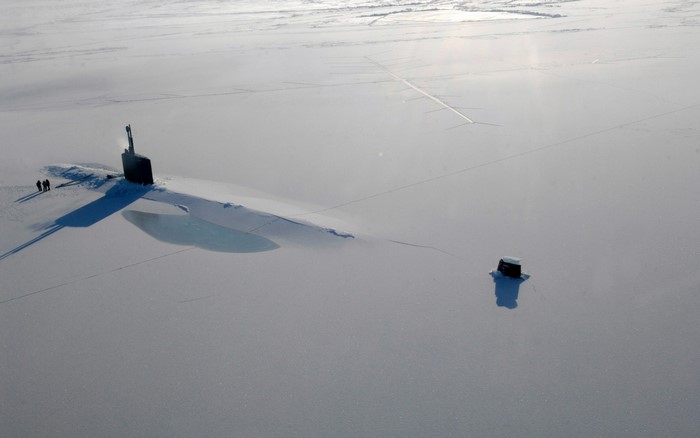 Submarine surfaced in Arctic ice with small shelter