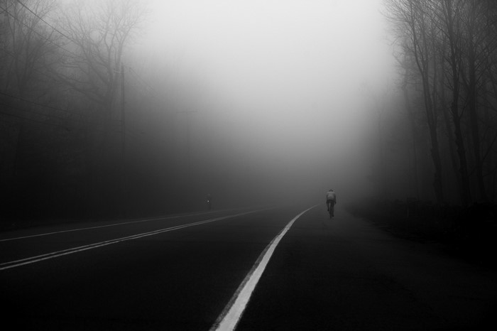 Cyclist on a foggy road