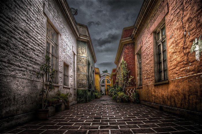 Alleyway between old buildings with cobblestone street