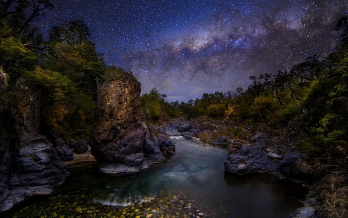 Milky Way over a rocky river canyon in Chile