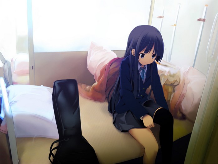 Akiyama Mio from K-On! sitting on a bed