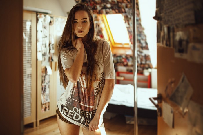 Woman with long brown hair wearing a t-shirt and shorts