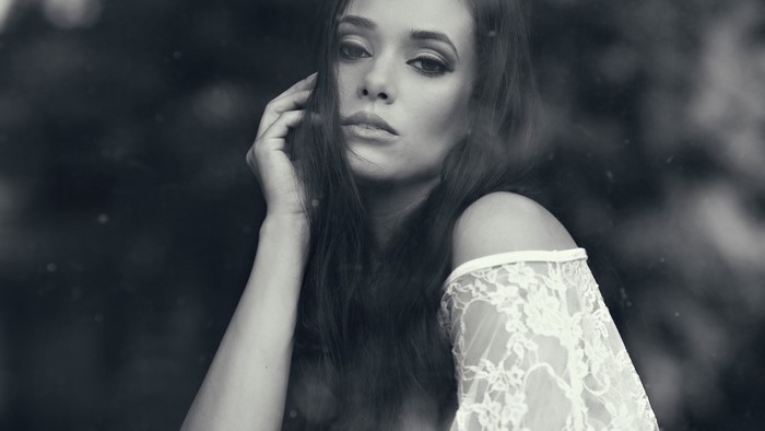Monochrome portrait of a woman with hand on face
