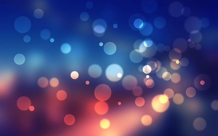 Abstract bokeh lights on a dark blue and red background