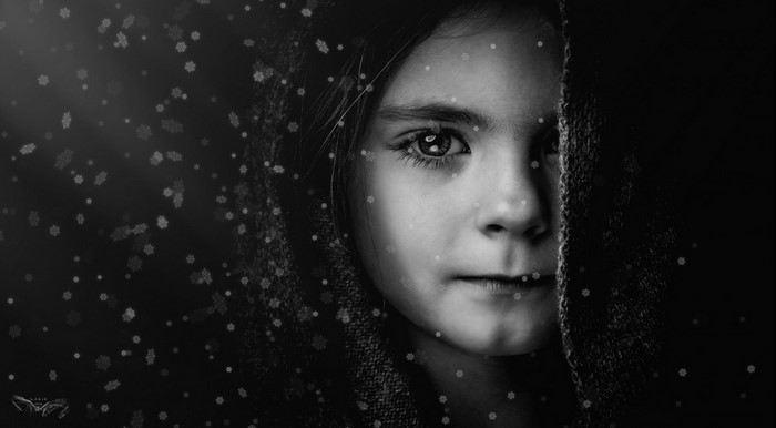 Monochrome portrait of a young girl with snowflakes