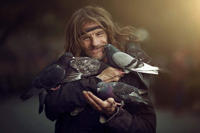 Man holding pigeons