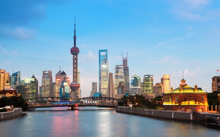 Shanghai skyline with Oriental Pearl Tower and river at dusk