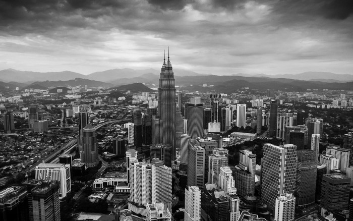 Monochrome aerial view of Kuala Lumpur skyline with Petronas Towers