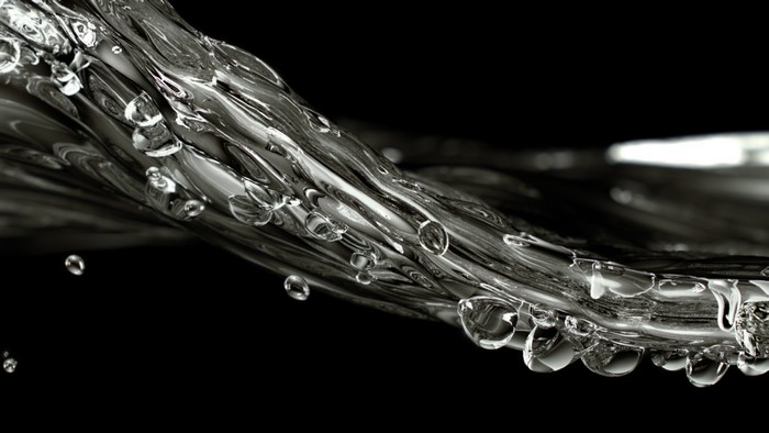 Monochrome closeup of water waves and drops