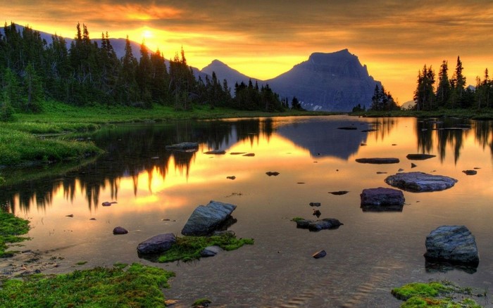 Sunset over a mountain lake with reflections
