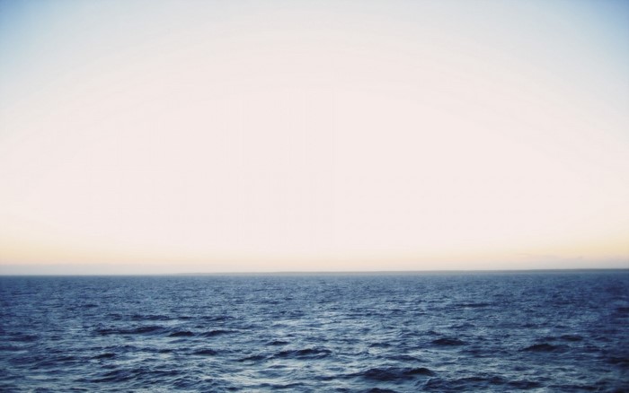 Ocean horizon at sunset with gentle waves