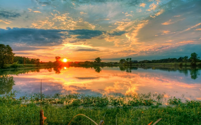 Sunset over a calm lake with reflections
