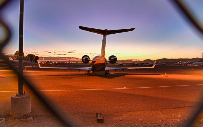 Private jet at airport during sunset