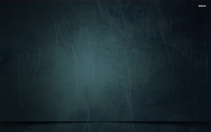 Dark textured surface with subtle lighting and a floor line