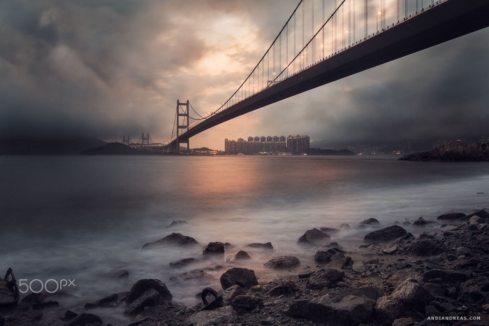 Tsing Ma Bridge at sunset with misty sea