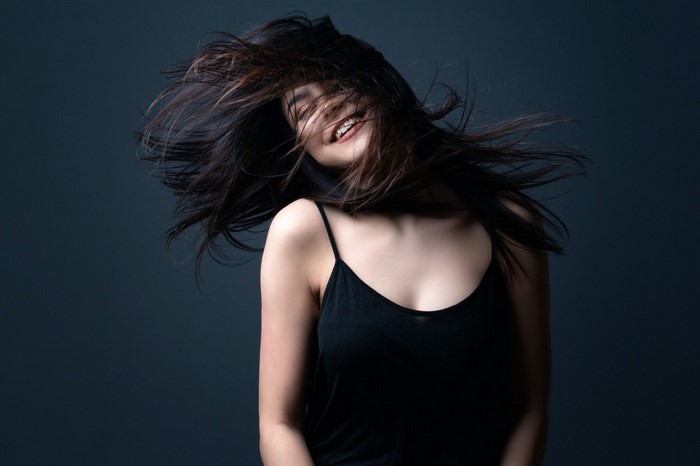 Woman with long dark hair blowing in the wind