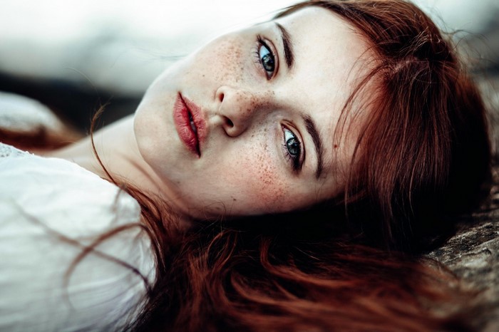 Close up portrait of a young woman with freckles