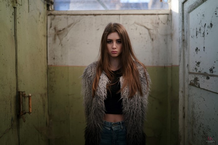 Young woman in a furry coat and jeans