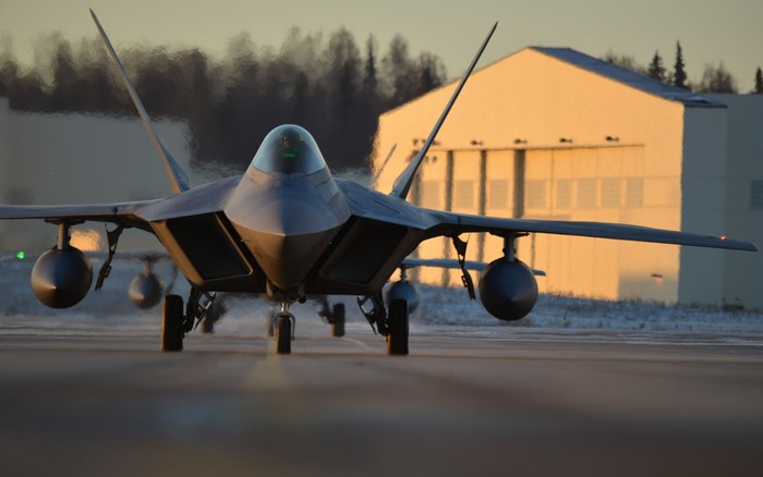 F-22 Raptor on a runway at sunset