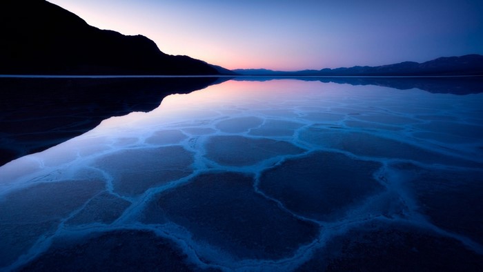 Salt flats reflecting the sky at dusk