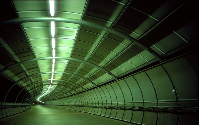 Green tunnel with lights at night