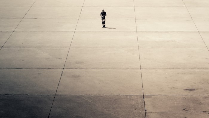 Man standing on a concrete surface with lines