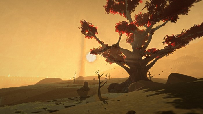 Desert landscape with a large tree at sunset