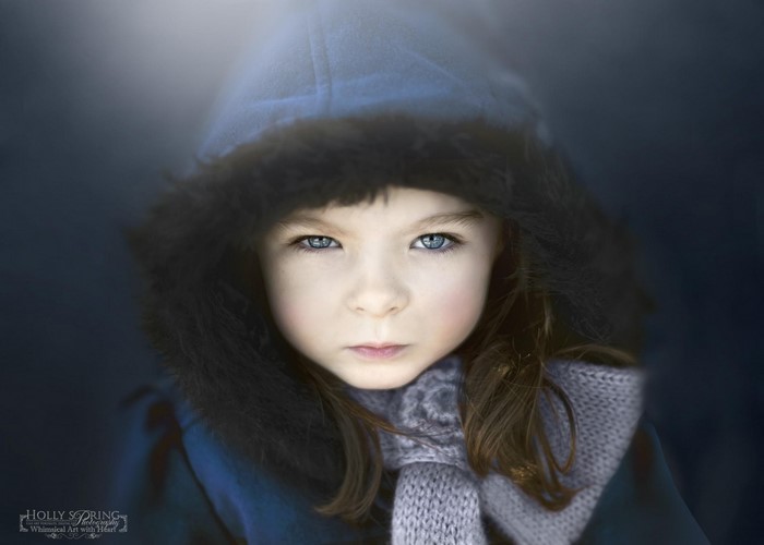 Girl in blue hooded coat with fur trim and scarf