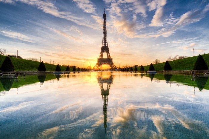 Eiffel Tower reflection at sunset with clouds