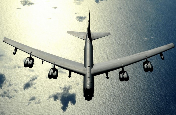 Boeing B-52 Stratofortress bomber flying over the ocean