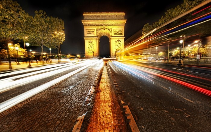 Arc de Triomphe at night with light trails