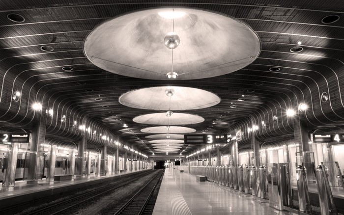Monochrome photography of a modern metro station ceiling with lights