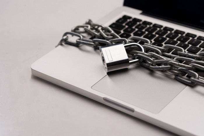 Laptop secured with a chain and padlock