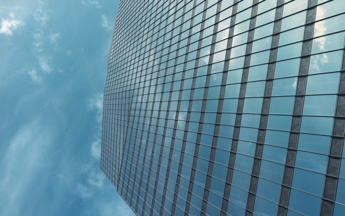 Modern skyscraper facade reflecting the sky