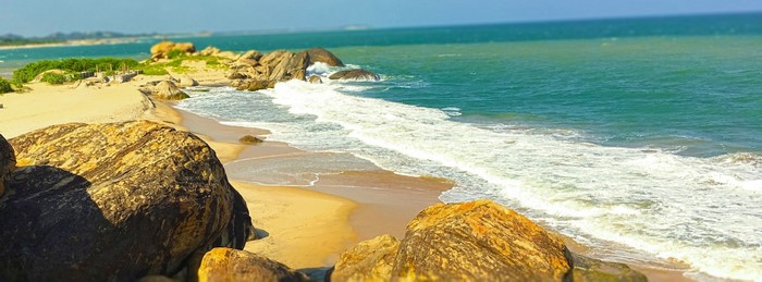 Rocky beach with waves crashing on the shore in Sri Lanka
