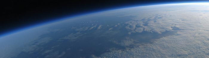 Earth's atmosphere from space with clouds