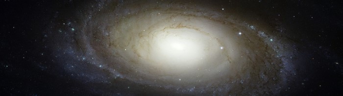 Spiral galaxy with bright core and starry background