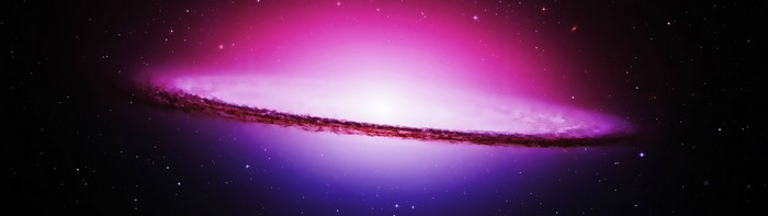 A spiral galaxy with a bright core and dark dust lane