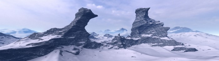 Snow-covered mountains with jagged rock formations under a cloudy sky