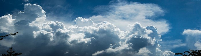 Cumulus clouds in a blue sky with sunlight